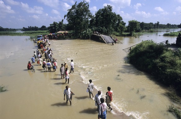 Ein Nebenfluss des Ganges ist wegen Starkregen überschwemmt und die Brücke kaputt. 