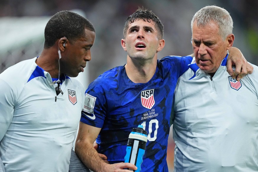 Soccer: FIFA World Cup, WM, Weltmeisterschaft, Fussball Qatar 2022-Iran at USA Nov 29, 2022 Doha, Qatar United States of America forward Christian Pulisic 10 is helped after sustaining an injury after ...