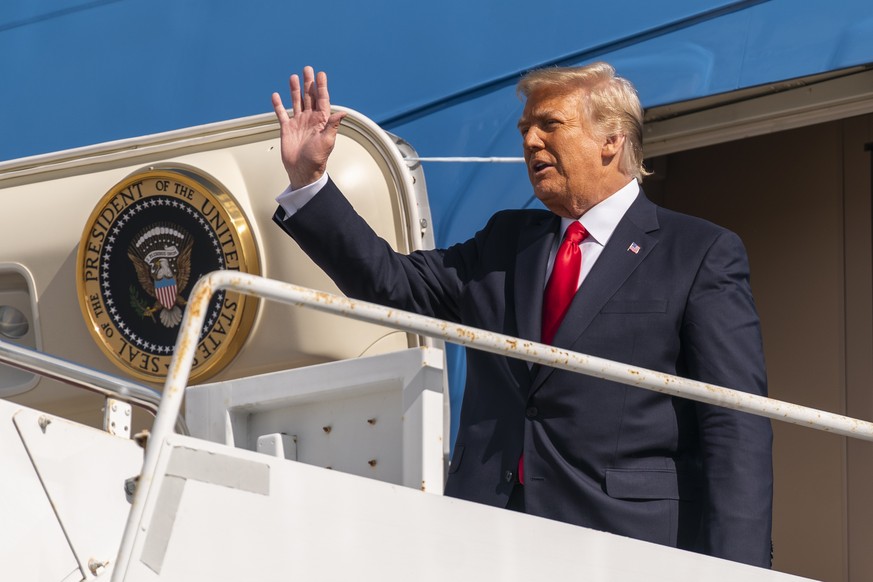 Former President Donald Trump waves as he disembarks from his final flight on Air Force One at Palm Beach International Airport in West Palm Beach, Fla., Wednesday, Jan. 20, 2021. (AP Photo/Manuel Bal ...