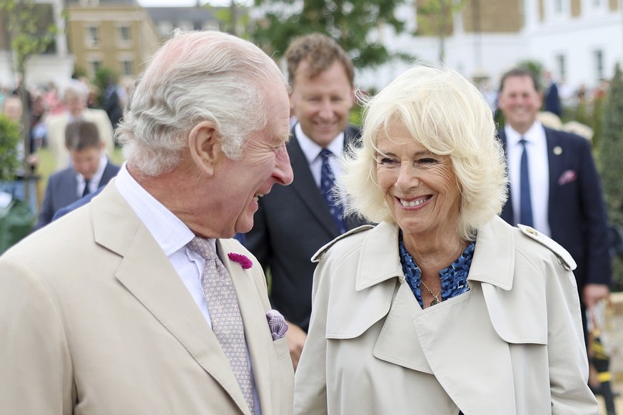 Britain&#039;s King Charles III and Queen Camilla share a moment as they visit Poundbury in Dorchester, England, Tuesday, June 27, 2023. (Chris Jackson, Pool via AP)
