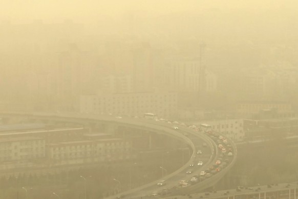 A view of a highway shot through a glass window during a dust storm in Beijing, Friday, March 10, 2023. Skyscrapers disappeared into the haze and air quality plummeted as China&#039;s capital was enve ...
