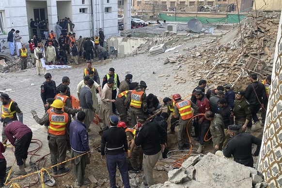 Security officials and rescue workers search bodies at the site of suicide bombing, in Peshawar, Pakistan, Monday, Jan. 30, 2023. A suicide bomber struck Monday inside a mosque in the northwestern Pak ...