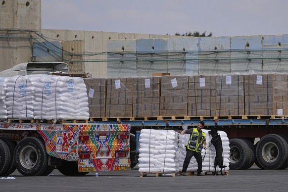 FILE - Trucks carrying humanitarian aid for the Gaza Strip pass through the inspection area at the Kerem Shalom Crossing in southern Israel, Thursday, March 14, 2024. Under heavy U.S. pressure, Israel ...