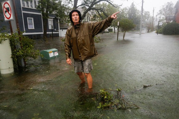A man walks through flooded streets during the passing of Hurricane Florence in the town of New Bern, North Carolina, U.S., September 14, 2018. REUTERS/Eduardo Munoz