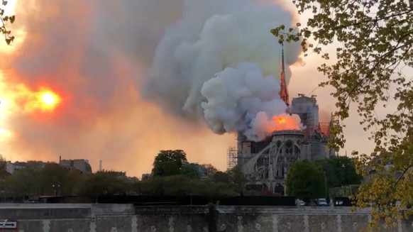 Smoke obstructs the sun as a fire destroys the Notre Dame Cathedral in Paris, France April 15, 2019 in this still image taken from social media video. Masha Alexandrova via REUTERS ATTENTION EDITORS - ...