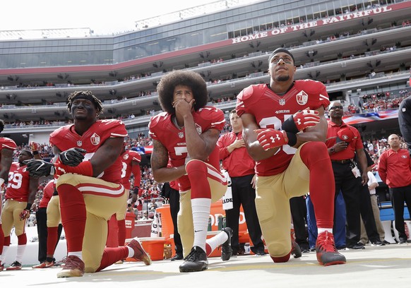 FILE - In this Oct. 2, 2016 file photo, from left, San Francisco 49ers outside linebacker Eli Harold, quarterback Colin Kaepernick and safety Eric Reid kneel during the national anthem before an NFL f ...