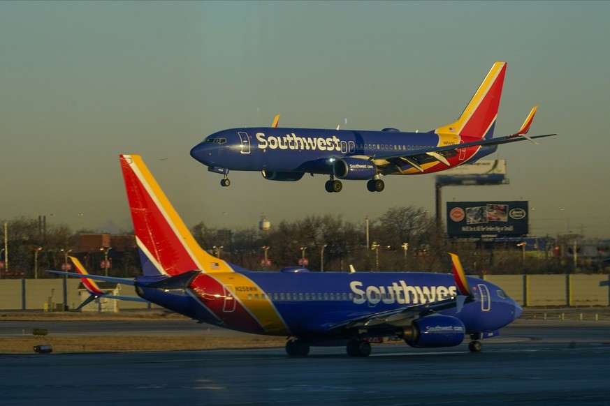 A Southwest Airlines plane prepares to land at Midway International Airport while another plane taxis on the ground, Sunday, Feb. 12, 2023, in Chicago. Airline passengers dealing with weather delays c ...