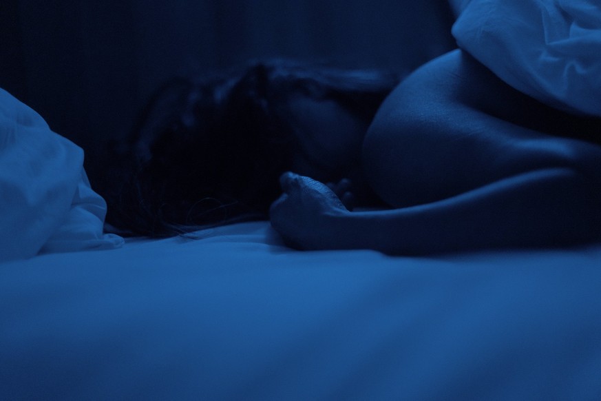 Person sleeping in bed in darkness Copyright: FrédéricxCirou B98344646 RECORD DATE NOT STATED