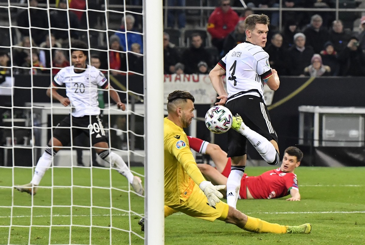 Germany's Matthias Ginter, center, scores the opening goal against Belarus' keeper Aleksandr Gutor during the Euro 2020 group C qualifying soccer match between Germany and Belarus in Moenche ...