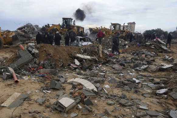 Palestinians search for the bodies after an Israeli strike in Zuweida, Gaza Strip, Monday, Jan. 29, 2024. (AP Photo/Adel Hana)