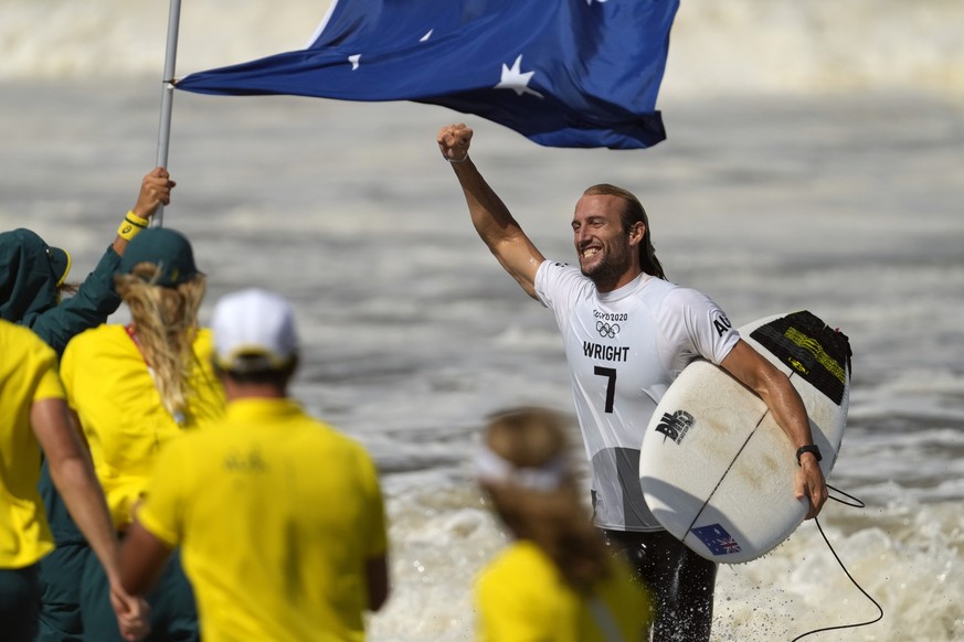 Australia&#039;s Owen Wright celebrates winning the bronze medal heat in the men&#039;s surfing competition at the 2020 Summer Olympics, Tuesday, July 27, 2021, at Tsurigasaki beach in Ichinomiya, Jap ...