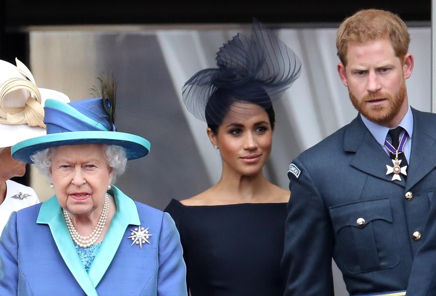 LONDON, ENGLAND - JULY 10: Queen Elizabeth II, Prince Harry, Duke of Sussex and Meghan, Duchess of Sussex on the balcony of Buckingham Palace as the Royal family attend events to mark the Centenary of ...