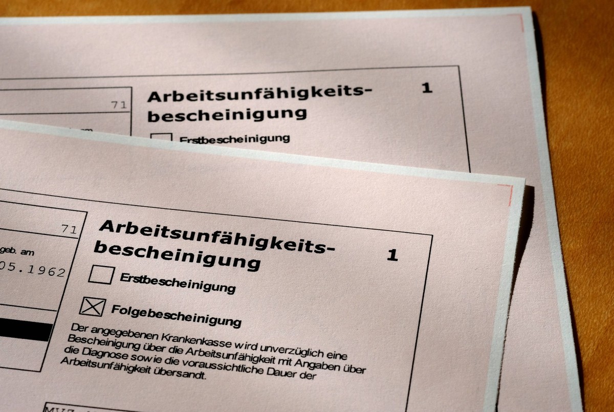 Leider krank. Die Arbeitsunfähigkeitsbescheinigung vom Hausarzt für den kranken Arbeitnehmer. München Bayern Deutschland *** Unfortunately sick The certificate of incapacity from the family doctor for ...