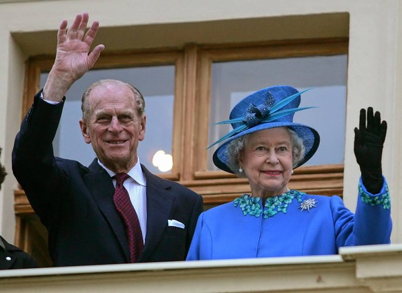 Britain s Queen Elizabeth II and Prince Philip wave from the balcony during their visit of the former estate Krongut in Postdam, just outside Berlin, on Wednesday, Nov. 3, 2004. Queen Elisabeth II sta ...