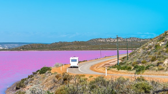 Scenic drive along the coast of Pink Lake Hutt Lagoon, Port Gregory, Western Australia. Campervan travel and tourism in Australia