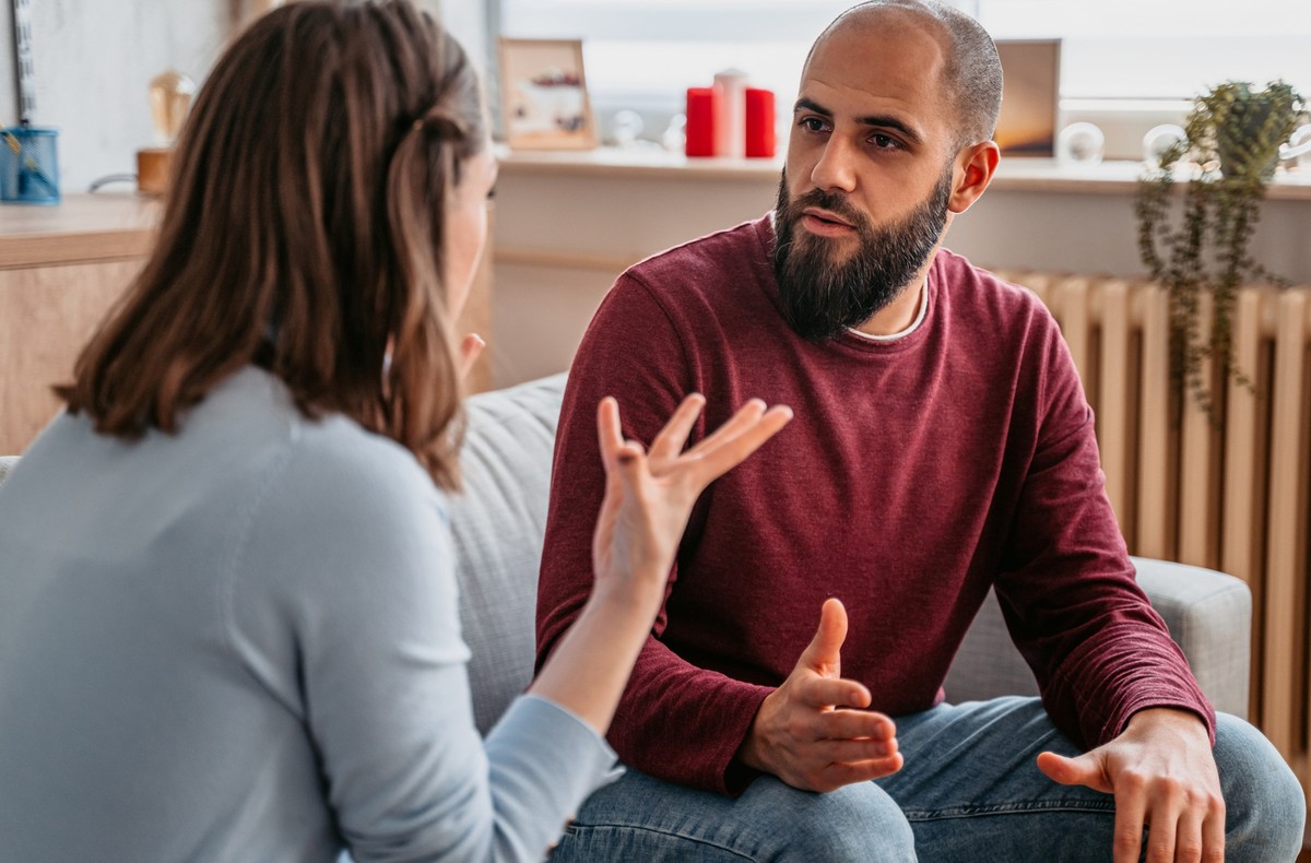Young couple with relationship problems arguing at home.