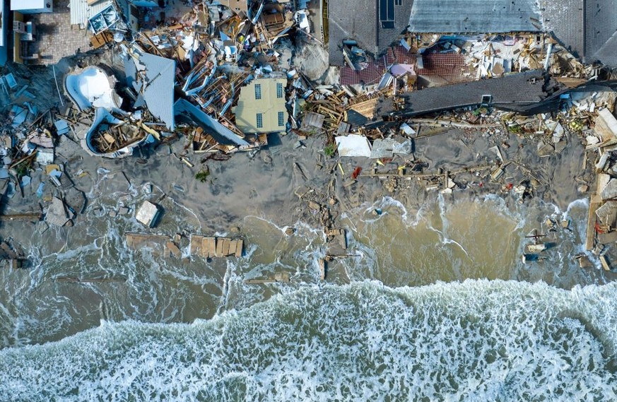 An aerial view of destroyed beachfront homes in the aftermath of Hurricane Nicole at Daytona Beach, Florida, on November 11, 2022. - The rare late storm sparked mandatory evacuation orders just weeks  ...