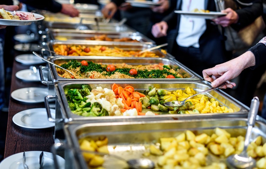 Cuisine Culinary Buffet Dinner Catering Dining Food Celebration Party Concept. Group of people in all you can eat catering buffet food indoor in luxury restaurant with meat and vegetables.