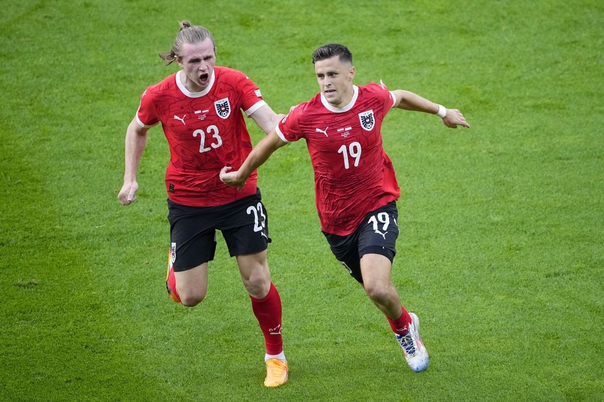 Austria&#039;s Christoph Baumgartner, right, celebrates with Patrick Wimmer after scoring his side&#039;s second goal during a Group D match between Poland and Austria at the Euro 2024 soccer tourname ...