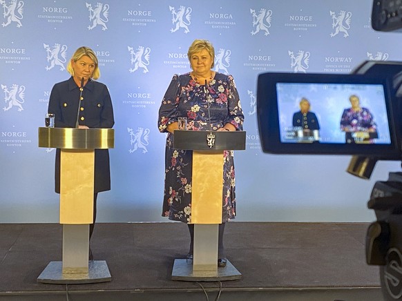 Norway&#039;s Acting Prime Minister Erna Solberg, right, and Minister of Justice Monica Mæland, left, speak at a press conference after the police briefing on the attack in Kongsberg, Norway, Wednesda ...