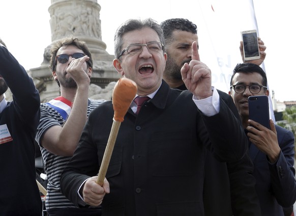 French far-left leader Jean-Luc Melenchon greets supporters and shouts slogans during a protest against French President Emmanuel Macron&#039;s government reforms, in Marseille, France, Saturday, Apri ...
