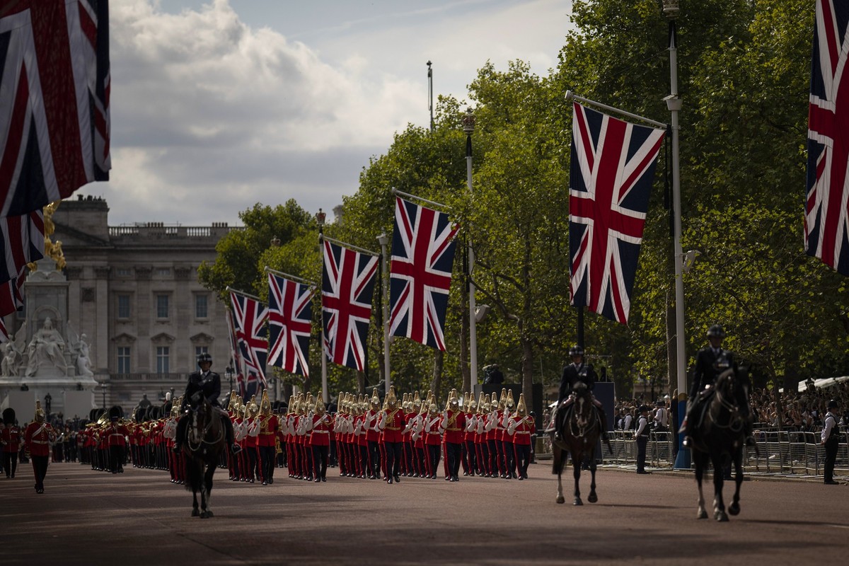 FILE - Guards escort the coffin of Queen Elizabeth II during a procession from Buckingham Palace to Westminster Hall in London, Wednesday, Sept. 14, 2022. On Friday, Sept. 16, The Associated Press rep ...