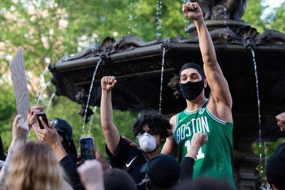 Enes Kanter of the Boston Celtics R joins protesters at a rally for George Floyd on Boston Common in Boston on Sunday, May 31, 2020. Civil unrest has broken out across the country in response to the k ...