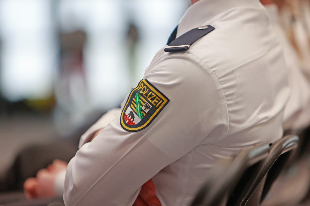 ARCHIV - 29.02.2024, Sachsen-Anhalt, Aschersleben: Ein Polizeianwärter sitzt zur Zeugnisausgabe für Absolventinnen und Absolventen der Fachhochschule Polizei im Ballhaus Aschersleben. (zu dpa: «101 ne ...