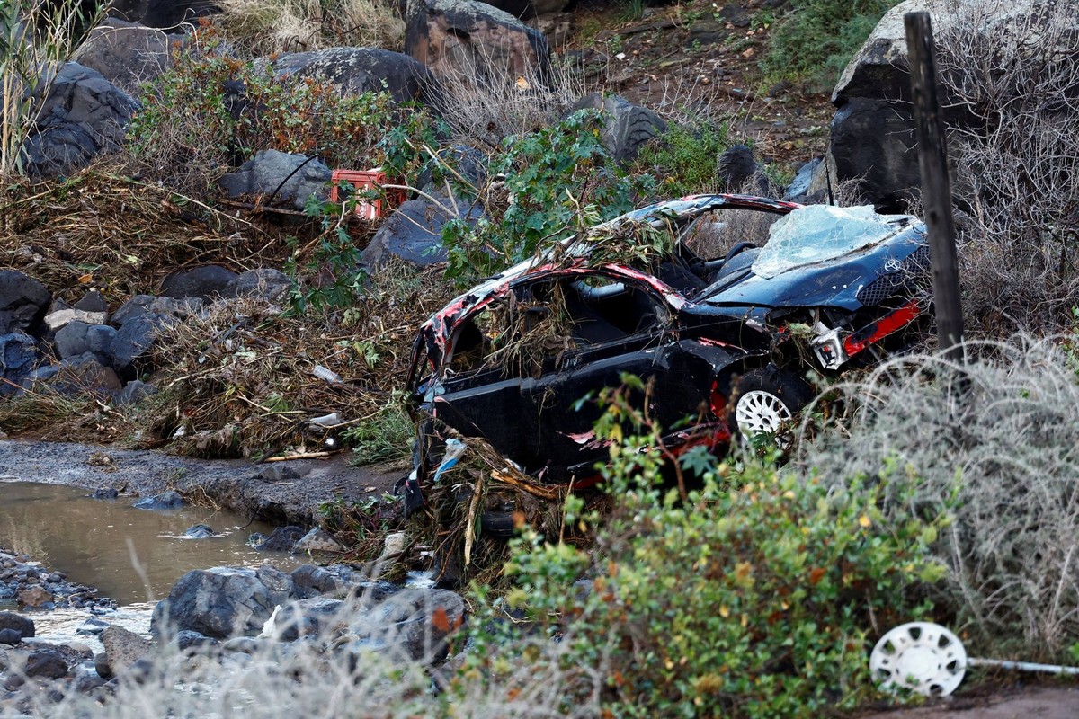 A car that was swept away by the rain lies amid vegetation in the Las Bachilleras ravine, in Telde, Gran Canaria, Spain, March 3, 2025. REUTERS/Borja Suarez