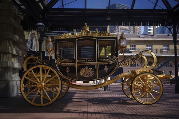 The Diamond Jubilee State Coach on display at the Royal Mews in Buckingham Palace, London, Tuesday April 4, 2023, in which King Charles III and the Queen Consort will travel to the coronation. King Ch ...