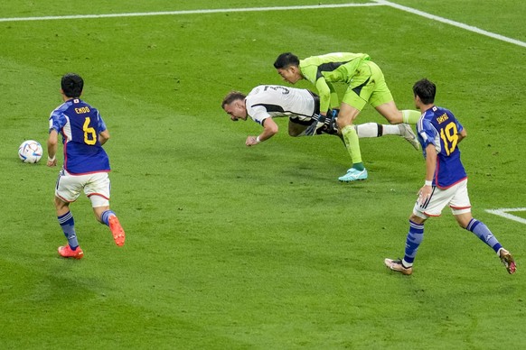 Germany&#039;s David Raum, is fouled by Japan&#039;s goalkeeper Shuichi Gonda during the World Cup group E soccer match between Germany and Japan, at the Khalifa International Stadium in Doha, Qatar,  ...