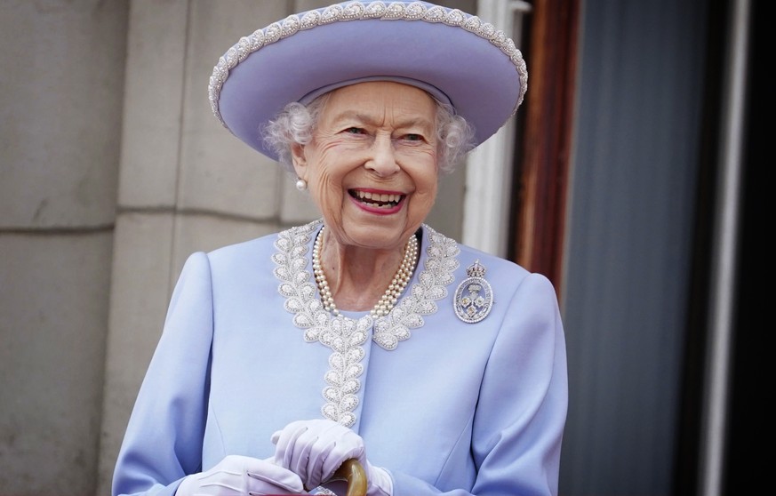 Queen Elizabeth II watches with a smile from the balcony of Buckingham Palace after the Trooping the Color ceremony in London, Thursday, June 2, 2022, on the first of four days of celebrations to mark ...