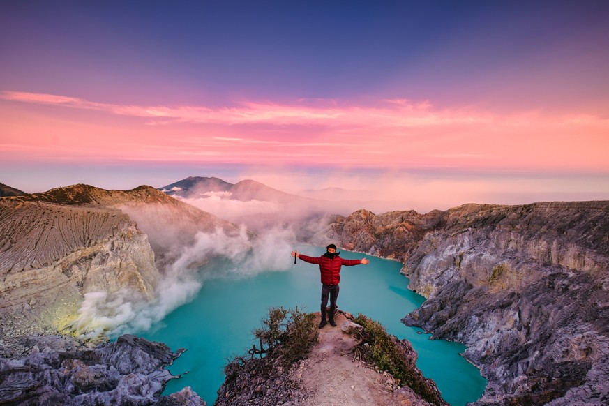 Successful traveler man standing on the crater of Kawah Ijen volcano with sunrise sky in the morning at East Java, Indonesia Model Released Property Released xkwx adventure alone asia banyuwangi beaut ...