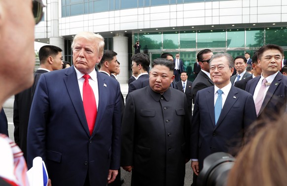 PANMUNJOM, SOUTH KOREA - JUNE 30: (SOUTH KOREA OUT): A handout photo provided by Dong-A Ilbo of North Korean leader Kim Jong Un, U.S. President Donald Trump, and South Korean President Moon Jae-in ins ...