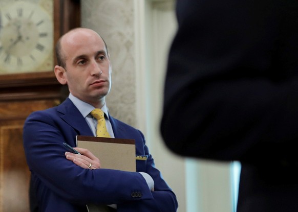 FILE PHOTO: White House senior advisor Stephen Miller listens as U.S. President Donald Trump hosts a law enforcement briefing in the Oval Office at the White House in Washington, U.S., July 15, 2020.  ...