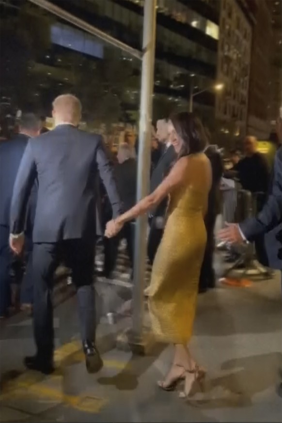 In this image from video, Prince Harry and his wife Meghan Markle exit Manhattan’s Ziegfeld Ballroom on Tuesday, May 16, 2023 in New York. The couple’s office says the pair and Meghan’s mother were fo ...