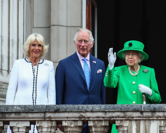 Queen Elizabeth II, accompanied by The Prince of Wales and The Duchess of Cornwall, The Duke and Duchess of Cambridge and their children, waves to the crowds from the Buckingham Palace balcony at the  ...