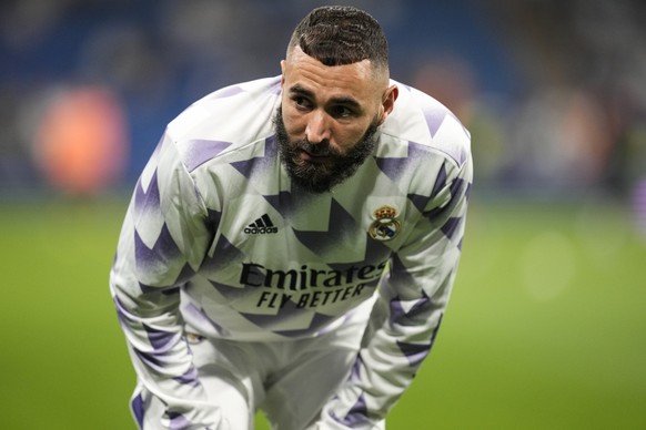 Real Madrid's Karim Benzema looks on as he warms up before the Champions League group F soccer match between Real Madrid and Shakhtar Donetsk at the Santiago Bernabeu stadium in Madrid, Wednesday, Oct ...