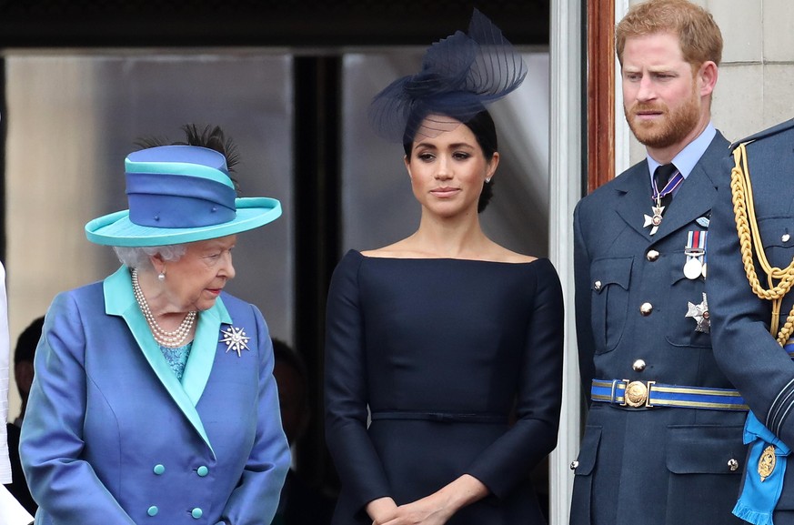 LONDON, ENGLAND - JULY 10: Queen Elizabeth II, Prince Harry, Duke of Sussex and Meghan, Duchess of Sussex on the balcony of Buckingham Palace as the Royal family attend events to mark the Centenary of ...