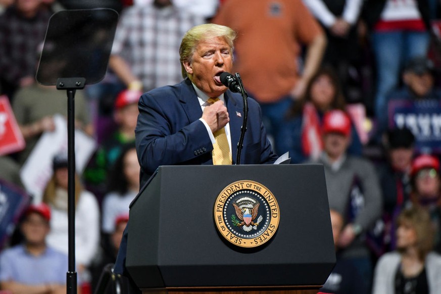 COLORADO SPRINGS, CO - FEBRUARY 20: President Donald Trump mocks choking while describing Democratic Presidential candidate Mike Bloomberg&#039;s debate performance during a Keep America Great rally o ...