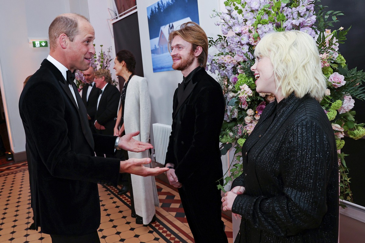 Britain&#039;s Prince William, left, speaks with performers Finneas O&#039;Connell and Billie Eilish upon arrival for the World premiere of the new film from the James Bond franchise &#039;No Time To  ...