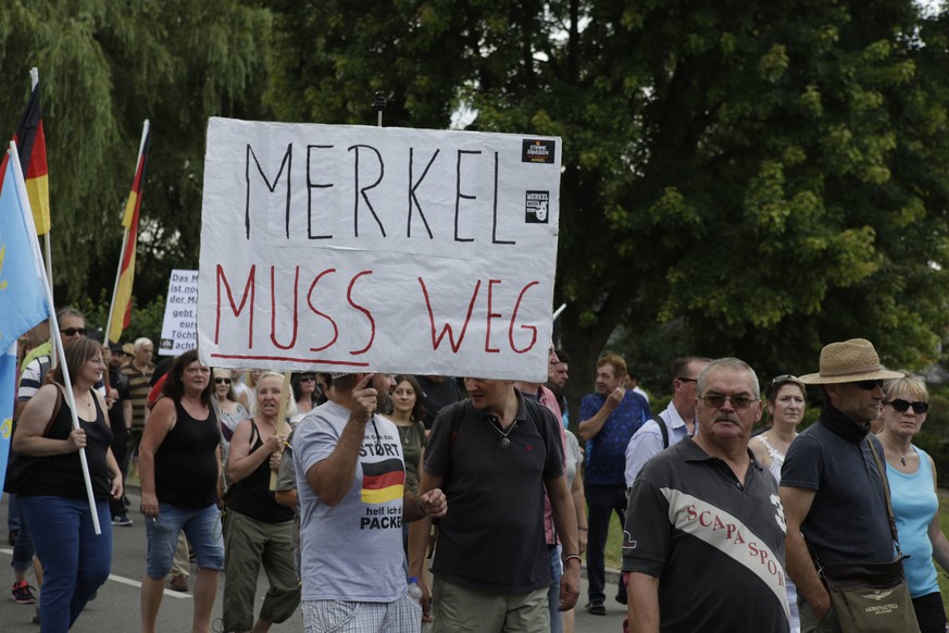 Germany: Monthly right-wing protest in Kandel A right-wing protester holds a sign that reads Merkel has to go . Around 200 people from right-wing organisations protested for the 10. time in the city o ...