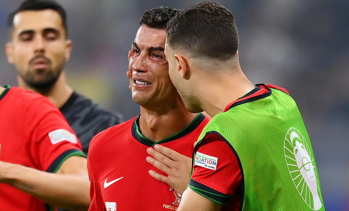 FRANKFURT AM MAIN, GERMANY - JULY 01: Cristiano Ronaldo of Portugal looks dejected as he is consoled by teammates ahead of the second half of extra-time during the UEFA EURO 2024 round of 16 match bet ...