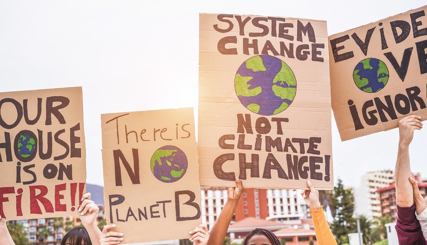 Group of demonstrators on road, young people from different culture and race fight for climate change - Global warming and enviroment concept - Focus on banners