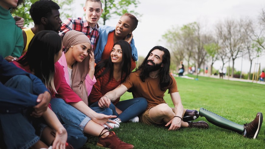 Group of young multiracial friends having fun together in park - Friendship and diversity concept