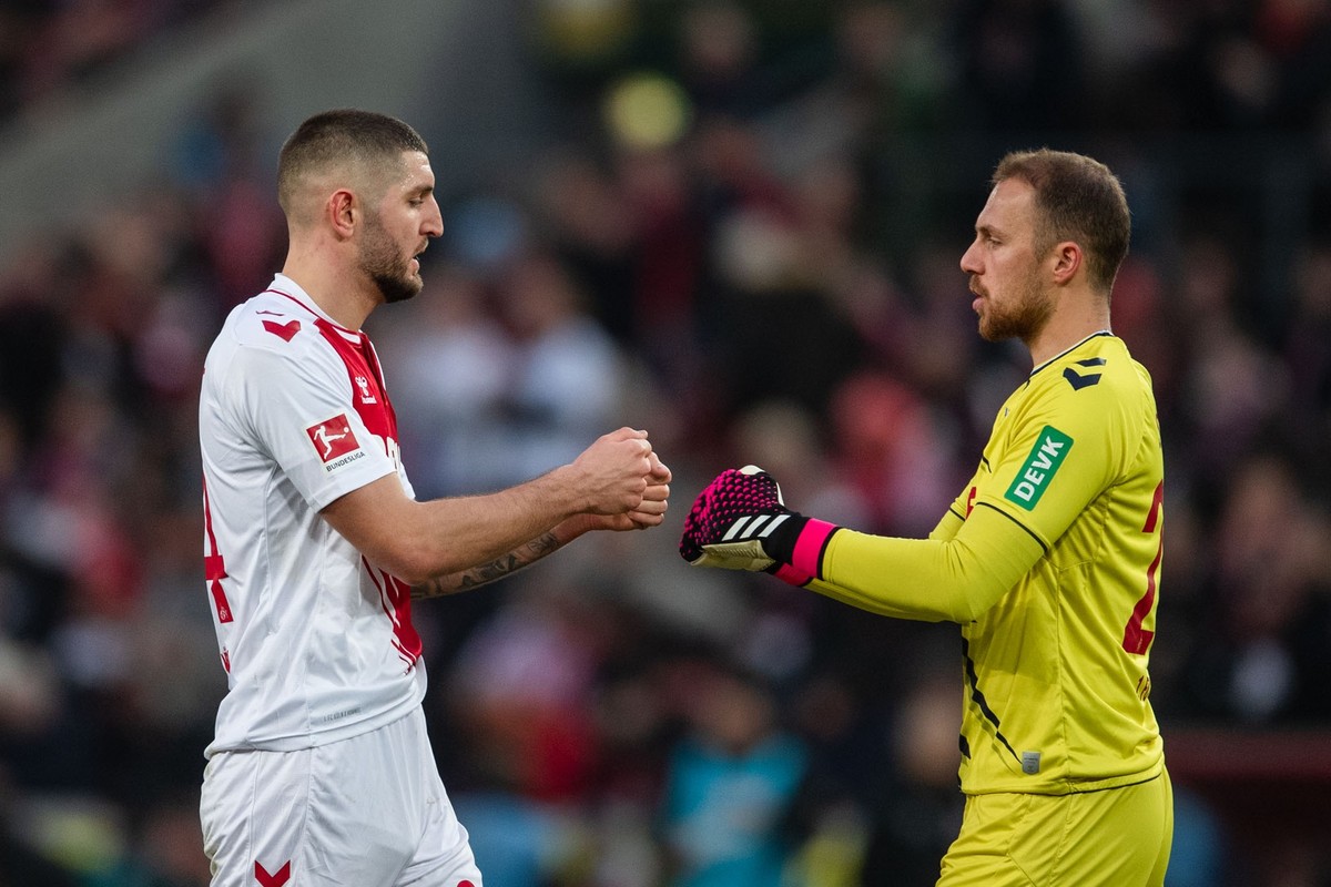 04.02.2023, Nordrhein-Westfalen, Köln: Fußball: Bundesliga, 1. FC Köln - RB Leipzig, 19. Spieltag, RheinEnergieStadion. Kölns Julian Chabot (l) und Torhüter Marvin Schwäbe klatschen sich nach der Part ...