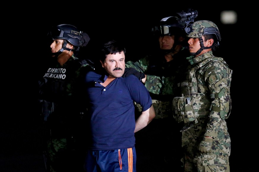 FILE PHOTO: Soldiers escort drug lord Joaquin &quot;El Chapo&quot; Guzman during a presentation to the media in Mexico City, Mexico January 8, 2016. REUTERS/Tomas Bravo/File Photo