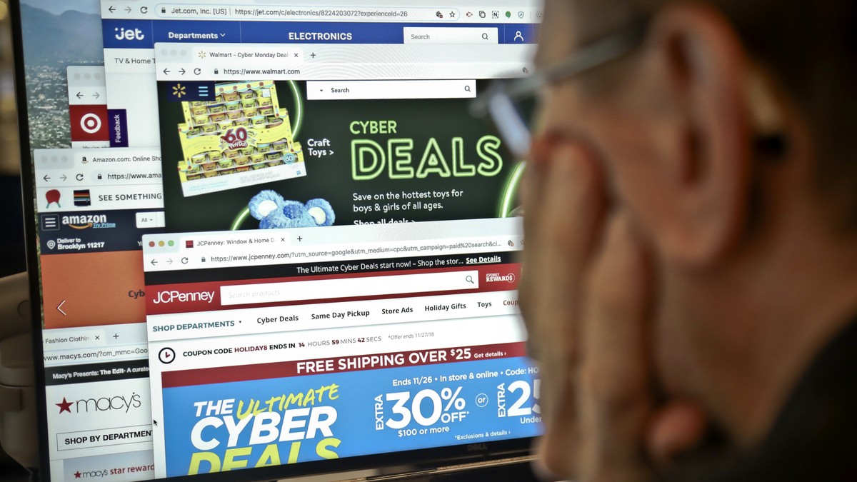 A journalist looks at a computer screen with webpages arranged to show Cyber Monday deals by various online retailers Monday Nov. 26, 2018, in New York. The physical rush of Black Friday and the armch ...