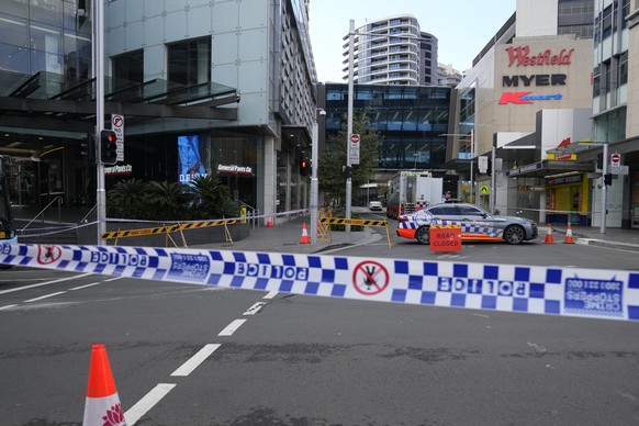 Police block a street near a crime scene at Bondi Junction in Sydney, Sunday, April 14, 2024, after several people were stabbed to death at a shopping center Saturday. Police have identified Joel Cauc ...