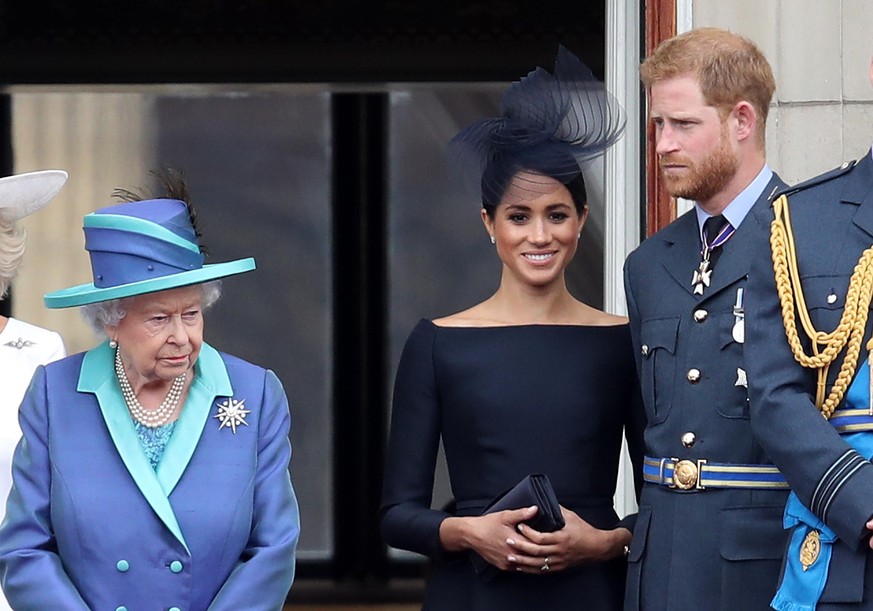 LONDON, ENGLAND - JULY 10: Queen Elizabeth II, Prince Harry, Duke of Sussex and Meghan, Duchess of Sussex on the balcony of Buckingham Palace as the Royal family attend events to mark the Centenary of ...